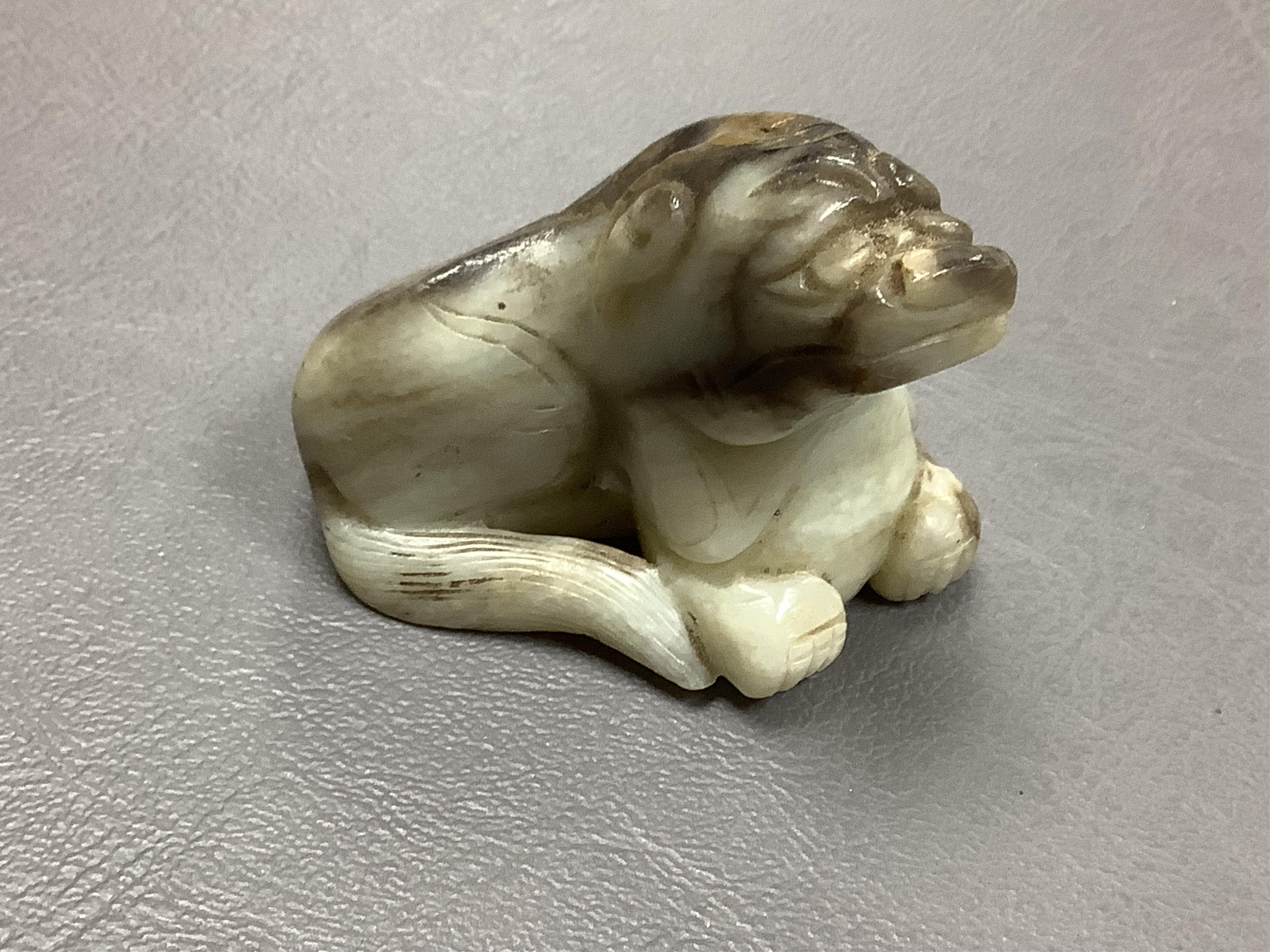 A Chinese white and black jade mythical beast, 5cm wide